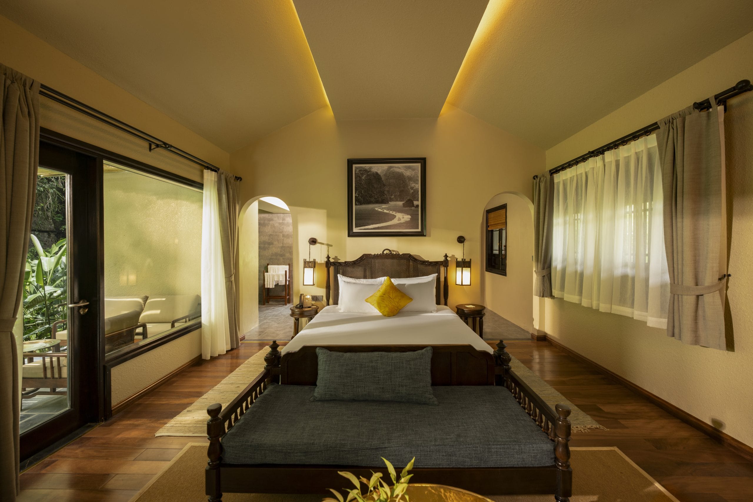 Natural timber textures, hand-woven textiles, and soft ambient lighting inside the Oasis Deluxe sanctuary.  