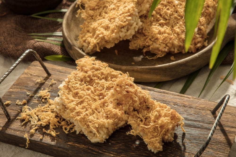 Crispy Burnt Rice (Cơm cháy), the famous local staple often enjoyed with a rich goat sauce near Hoa Lư Ancient Capital.