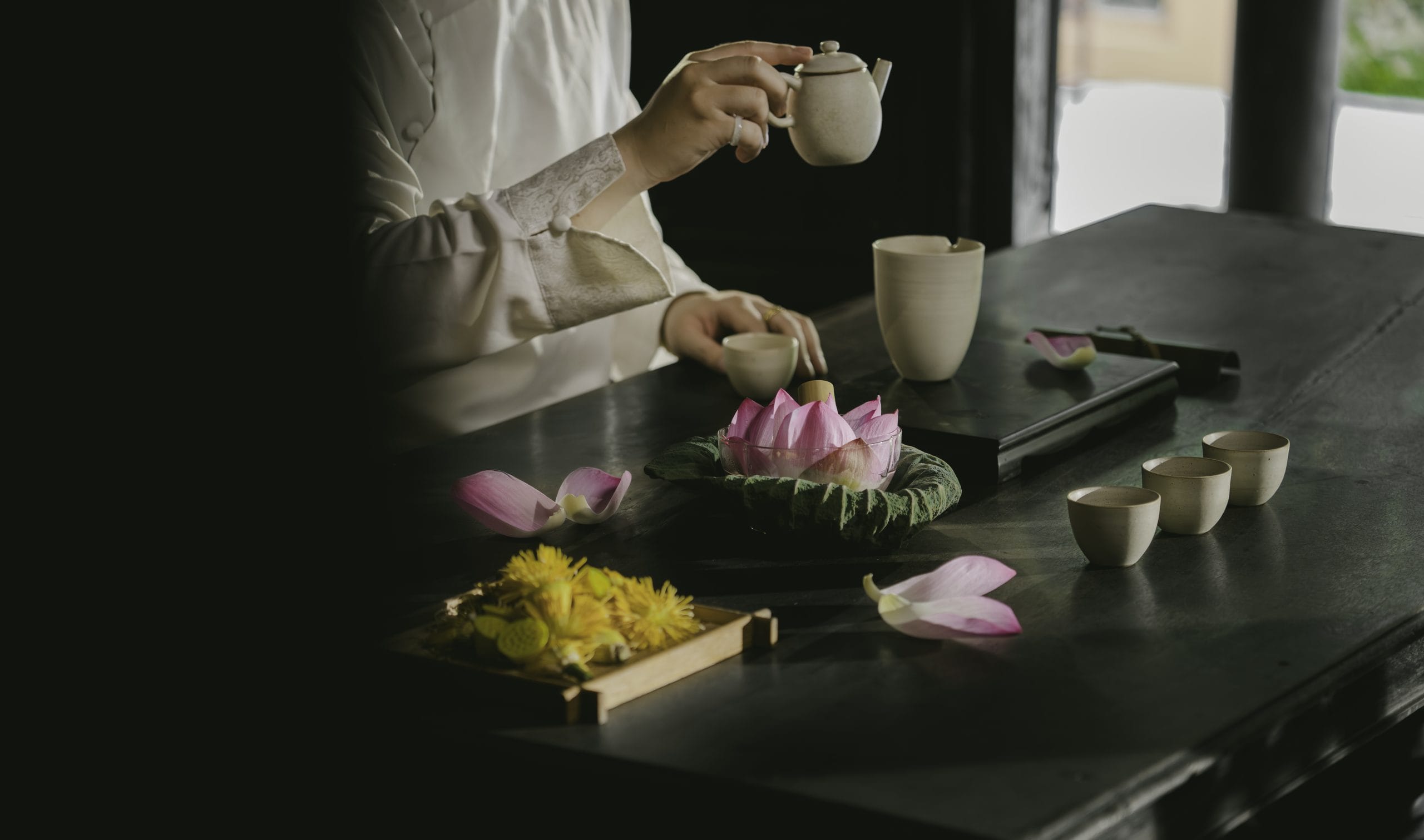 enjoying warm herbal tea and handmade regional delicacies on a covered veranda overlooking mist-draped karst peaks