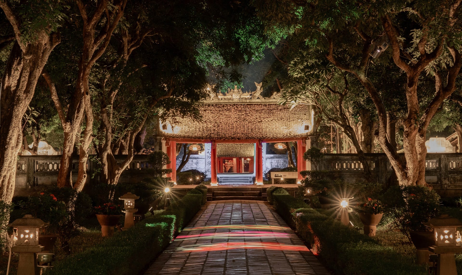 The historical structures illuminated by light art during the captivating Temple of Literature Hanoi night tour.