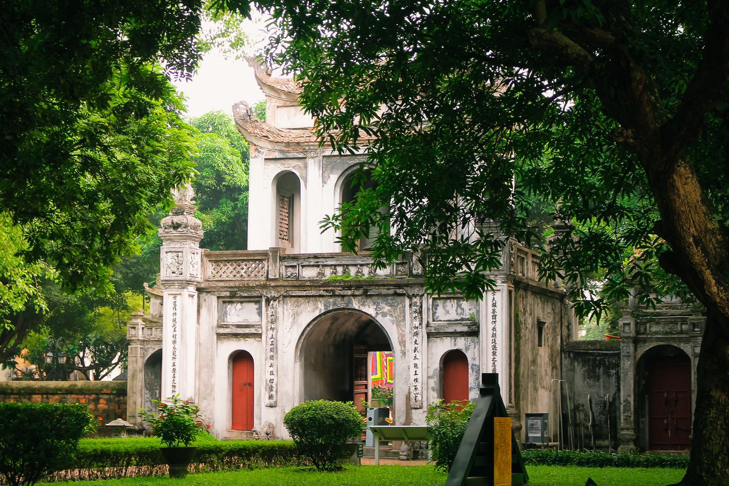 The two-tiered front gate of the Temple of Literature Hanoi, adorned with couplets and artistic carvings.