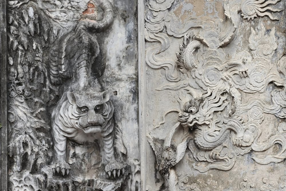 bas relief depicting Carp Turning into a Dragon Fierce Tiger Descending the Mountain on two side of the gate