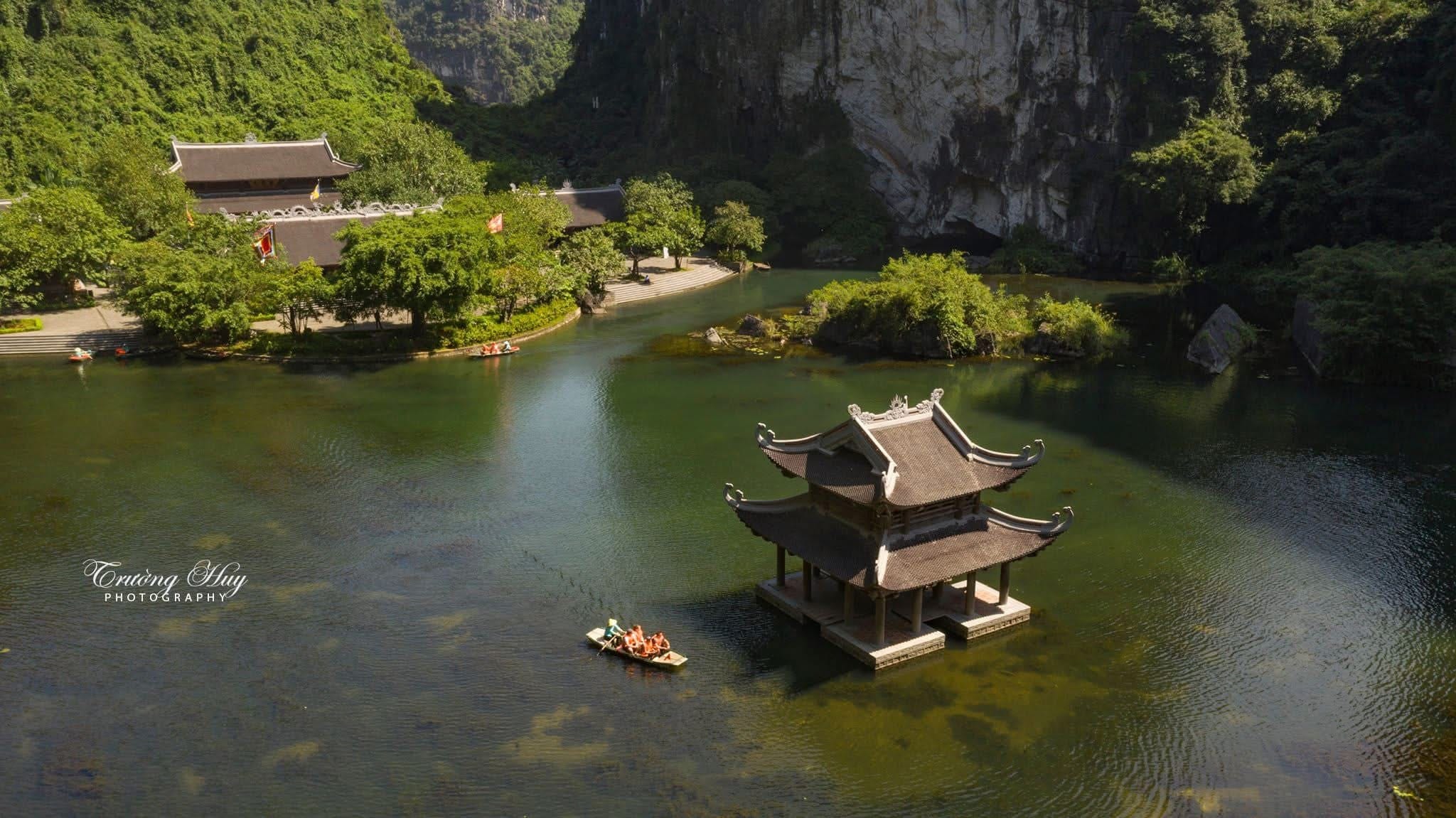 Drifting through the UNESCO-listed waterways of Trang An on a Ninh Binh from Hanoi Tour.