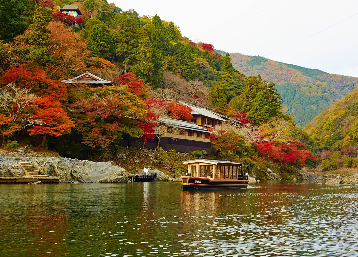 Scenic boat ride up the Hozugawa River, the unique entrance to the secluded Hoshinoya Kyoto.
