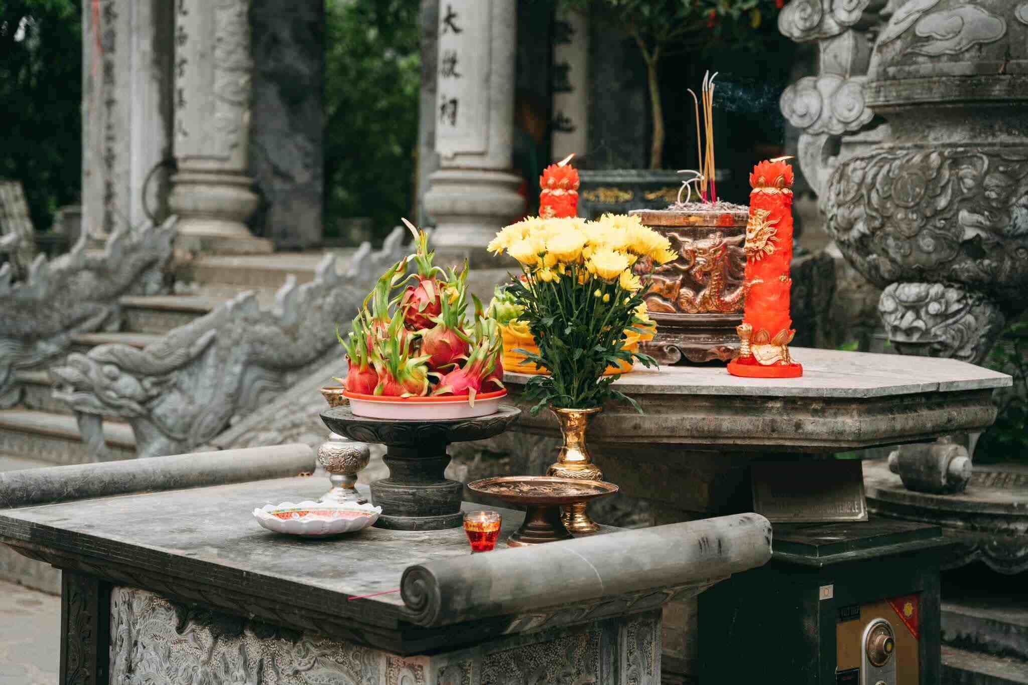 Travelers lighting incense and offering silent prayers in the serene atmosphere of the temple.