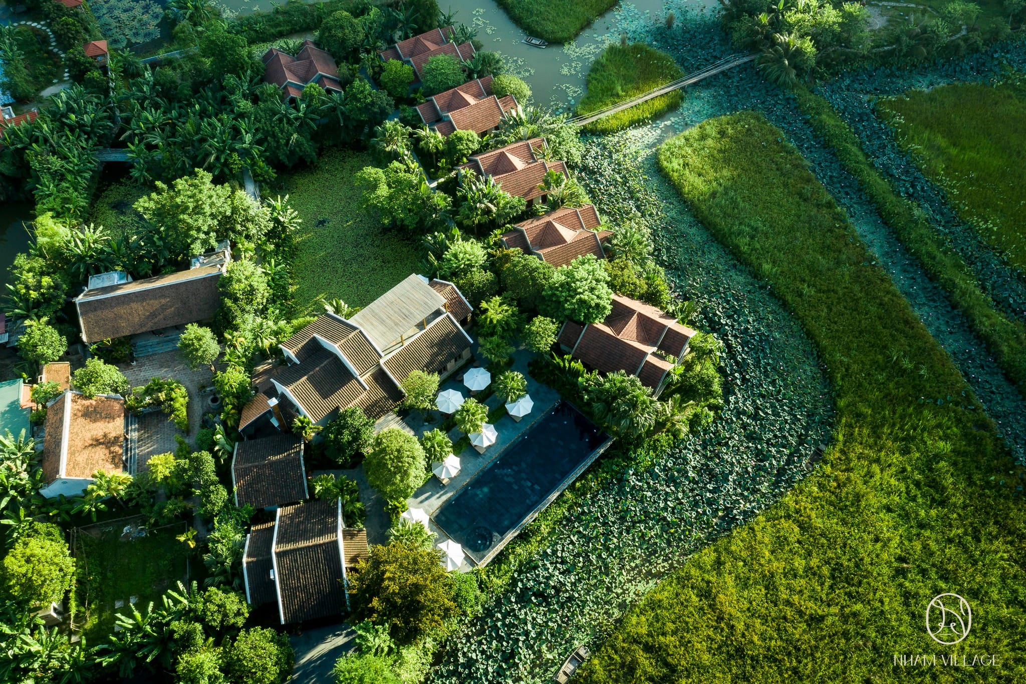Traditional Northern homes at Nham Village, designed with terracotta roofs and stone courtyards, offering authentic cultural luxury.