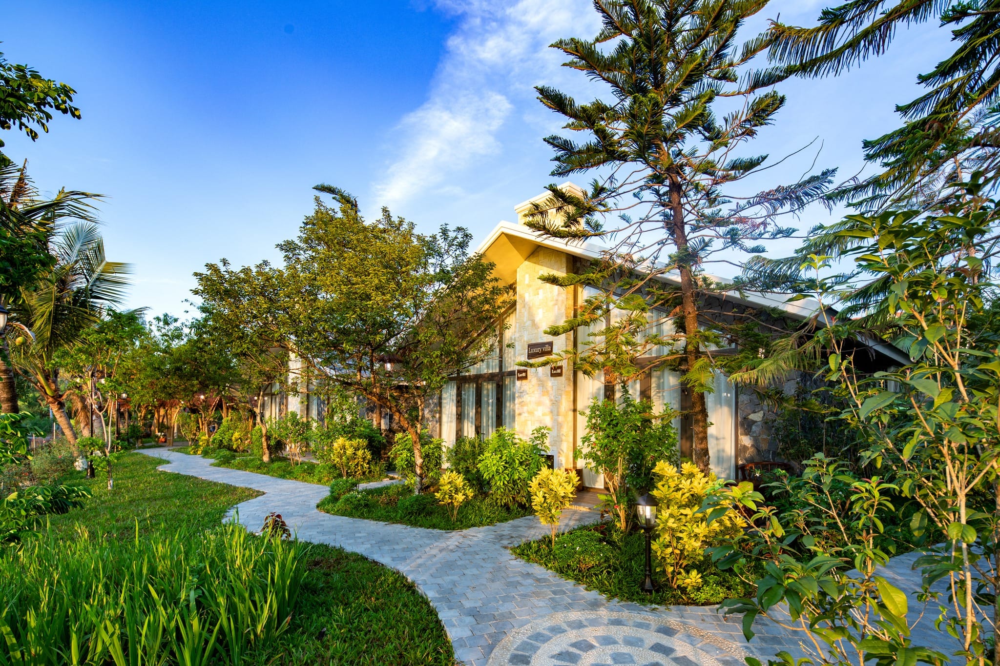 Meditative pathways and stylish bungalows at Bai Dinh Garden, a spiritual and intimate Trang An Resort.