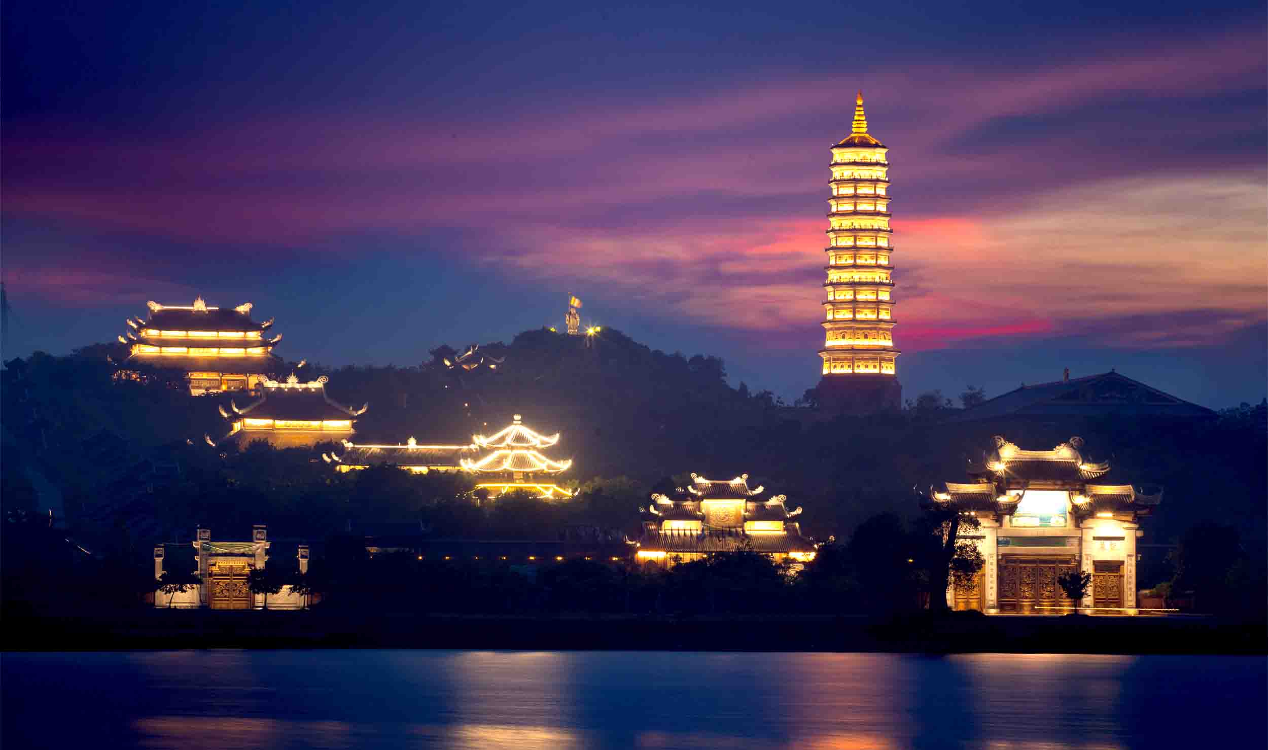 A wide shot of the complex showcasing the pagoda illuminated at dusk, before the 7:00 PM closing time.