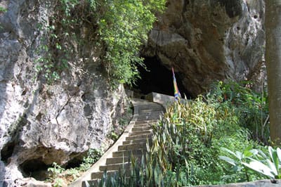 Sunlight streaming into the naturally lit chamber of Thien Huong Cave.