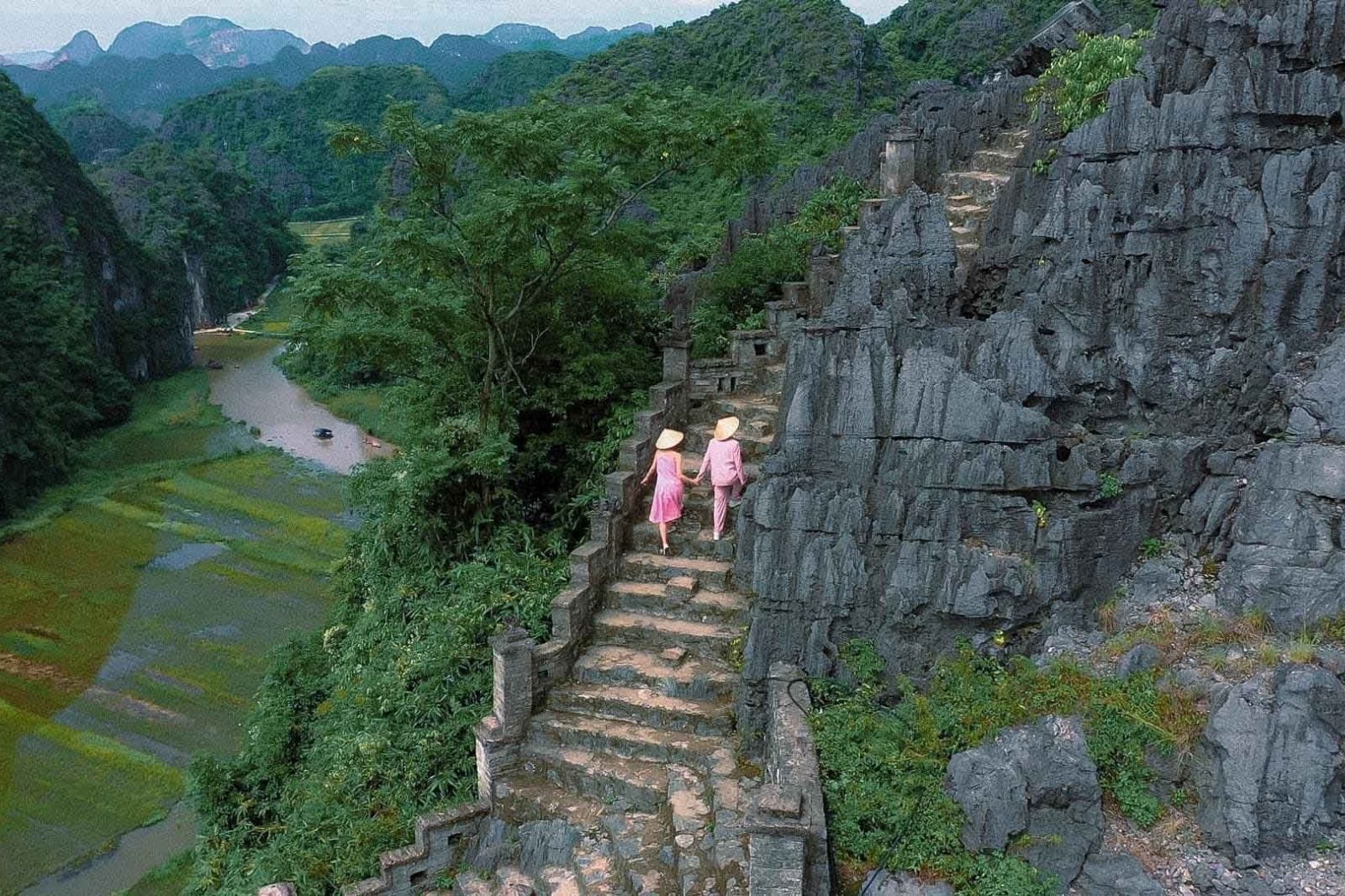 Conquering the 500 stone steps of Mua Cave for the best view on a Ninh Binh from Hanoi Tour.