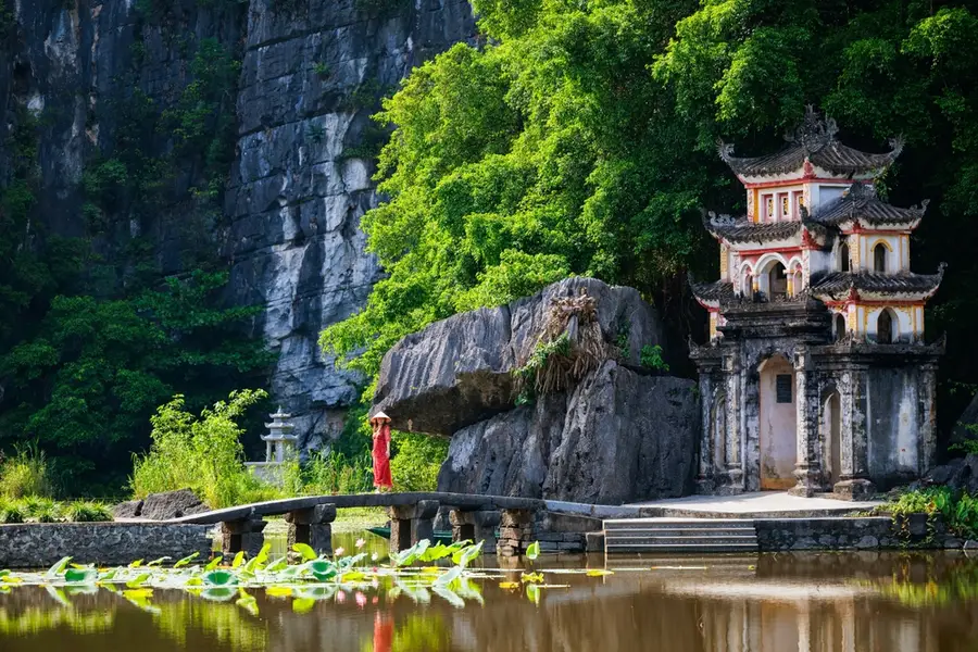 The ancient three-tiered Bich Dong Pagoda built gracefully into the side of a mountain.