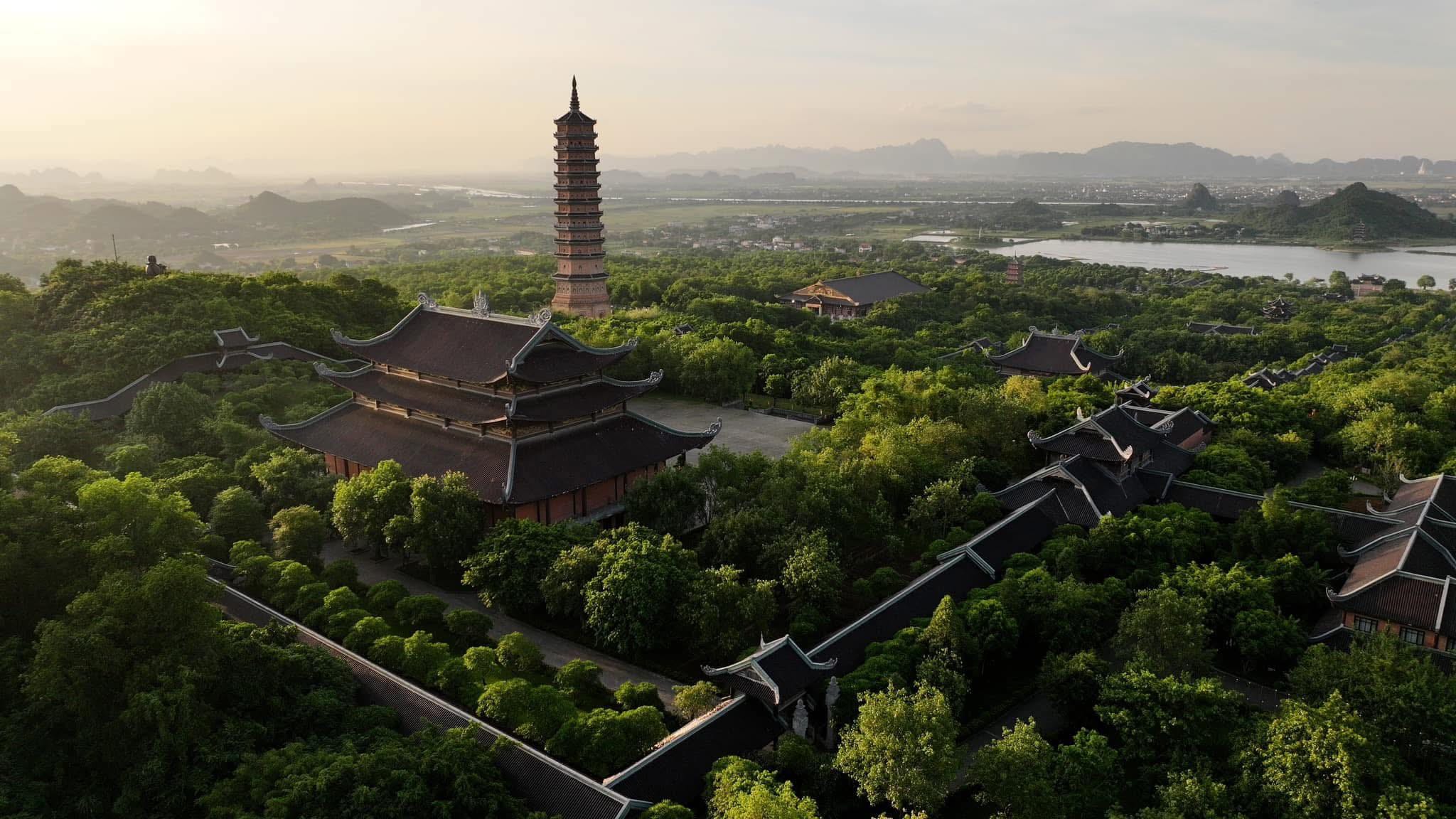 Soft morning sunlight filtering across the peaceful limestone mountains and pagodas